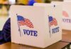 Election Anxiety Spurs Veteran Poll Takeover voting booth with American flag graphics