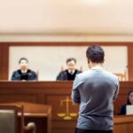Cemetery Fight Night Shocks Ohio defendant stands before judges in a courtroom