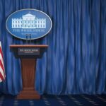 Judge Smacks Down White House Ban White House press briefing podium with U.S. flag and blue curtain