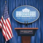 White House Boast Meets Uranium Reality White House press briefing podium and US flag