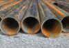 Trump’s $15B Steel Play Shocks Iowa Rusty metal pipes laid on gravel