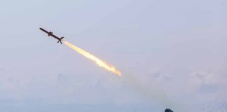 Cruise missile launches from mobile launcher in open field