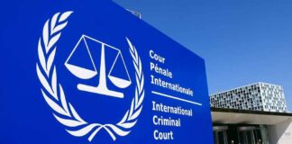 International Criminal Court sign with scales emblem outside modern building