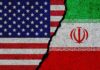 U.S. and Iran flags split by a jagged crack