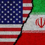 U.S. and Iran flags split by a jagged crack