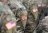 U.S. flag patches on camouflage military uniforms