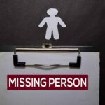 clipboard with missing person notice and paper cutout figure