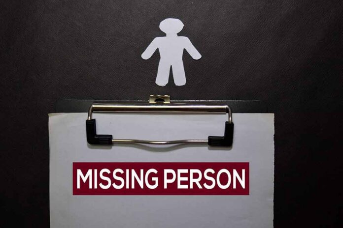 clipboard with missing person notice and paper cutout figure