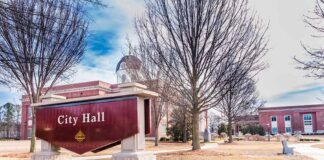 City Hall sign in front of a red-brick municipal building