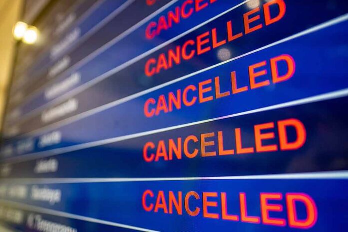 airport departures board showing multiple cancelled flights