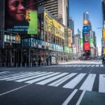 Times Square street with crosswalks and towering digital billboards