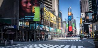 Times Square street with crosswalks and towering digital billboards