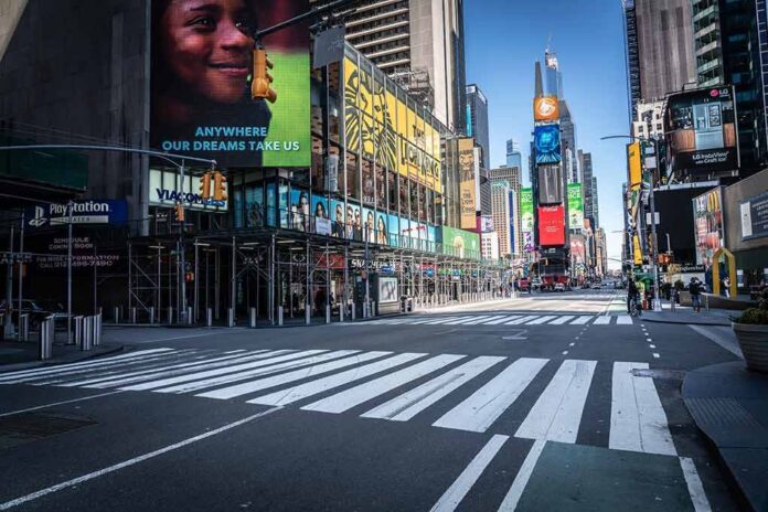 shutterstock_1698795406 Times Square street with crosswalks and towering digital billboards