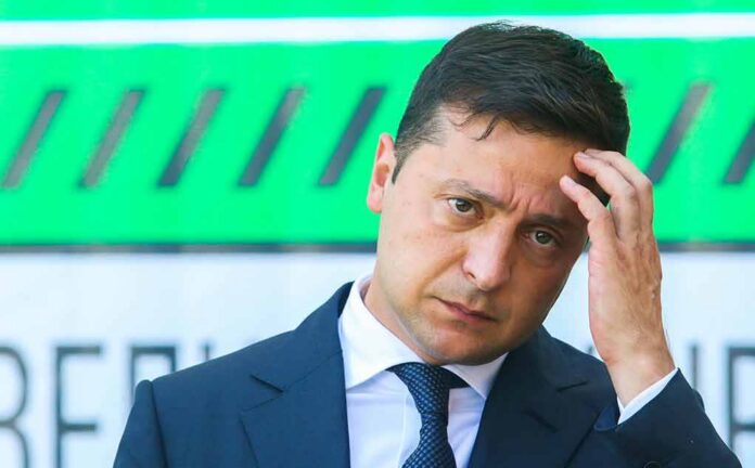 man in a suit touching his head