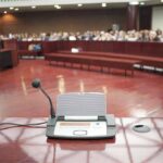 Budget Brawl: Justices Demand Millions Conference microphone on a podium in a courtroom