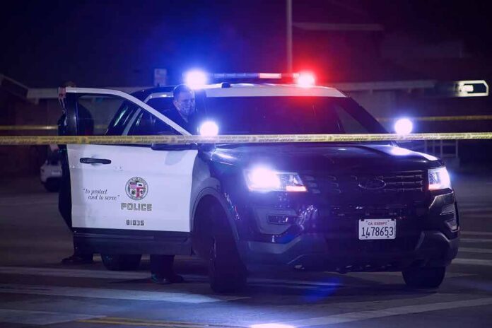 Police SUV with flashing lights at night behind yellow tape