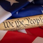 250-Year Capsule Sparks Outrage — Who’s Missing? United States Constitution scroll on American flag