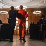Convicted Teen Deported After Fairfax Assaults Prisoner in orange jumpsuit escorted by officer in a courtroom