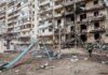 Kyiv Ablaze After Mixed Strikes Damaged apartment building behind a playground slide
