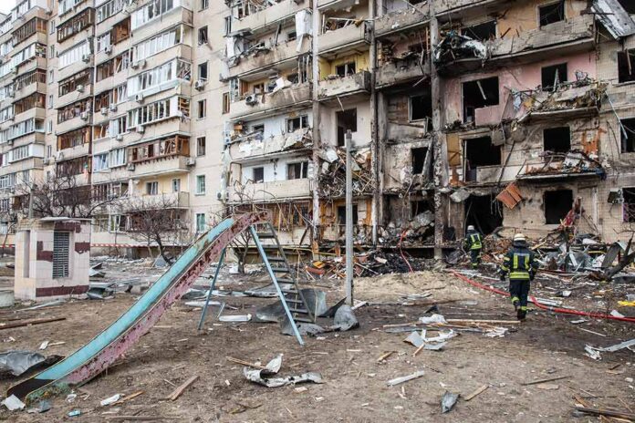 Damaged apartment building behind a playground slide