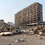 Burned-out cars amid a gutted high-rise building