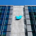 Court Clash: DOJ Joins Musk Against EU Twitter bird logo on a modern office building facade