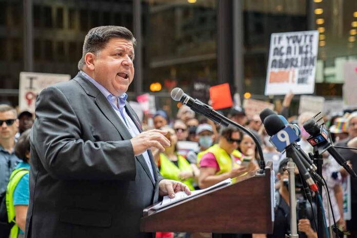 Speaker at a podium addressing a crowd with microphones and protest signs