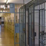 Prison corridor with barred doors