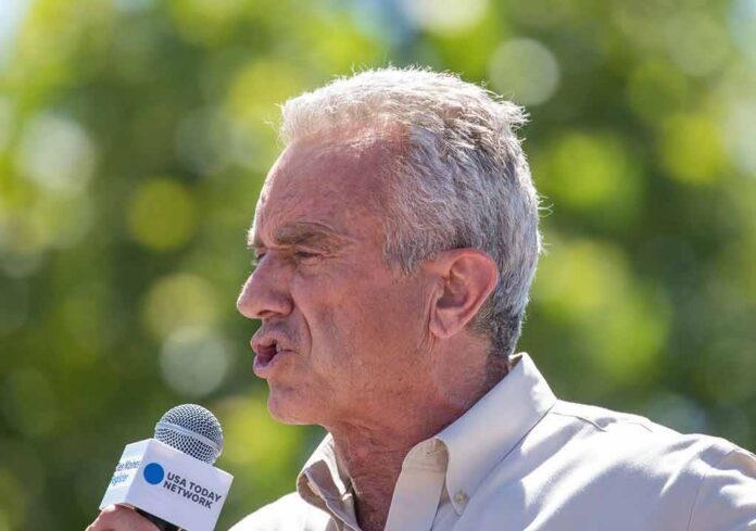 shutterstock_2346739541-7 man speaking into a microphone outdoors