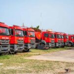 Row of red fire trucks parked in a lot