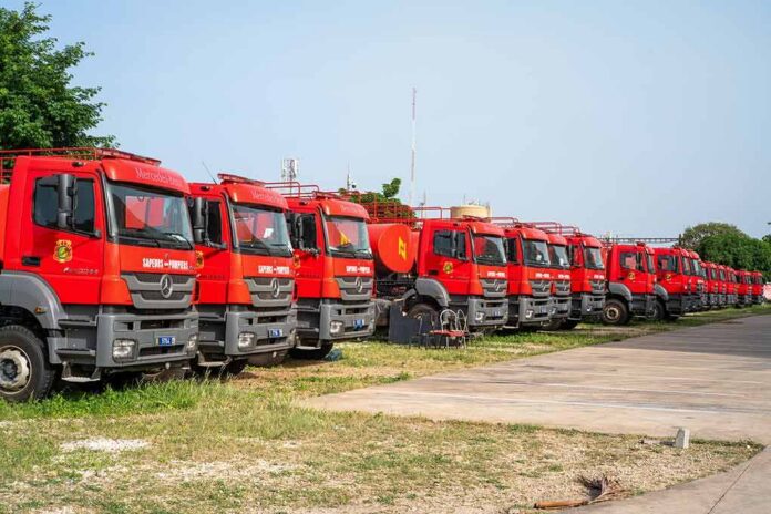 shutterstock_2373969907 Row of red fire trucks parked in a lot