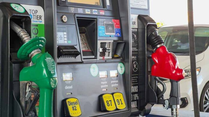 Gas pump with green diesel and red gasoline nozzles