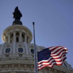 U.S. flag waves before the Capitol dome