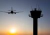 Software Meltdown Snarls Britain’s Airspace Airplane approaching runway near airport control tower at sunset