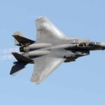 fighter jet banking in clear sky
