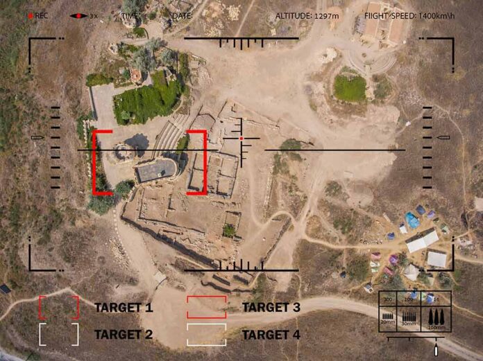 Aerial view through drone HUD of archaeological ruins and surrounding campsite