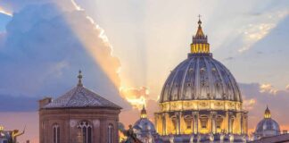 St. Peter's Basilica dome at sunset with glowing sky
