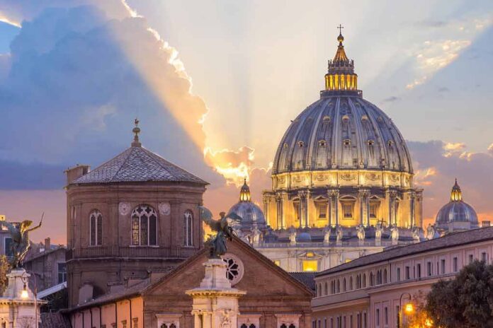 St. Peter's Basilica dome at sunset with glowing sky