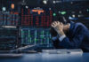 Trader stressed out by multiple declining stock charts.