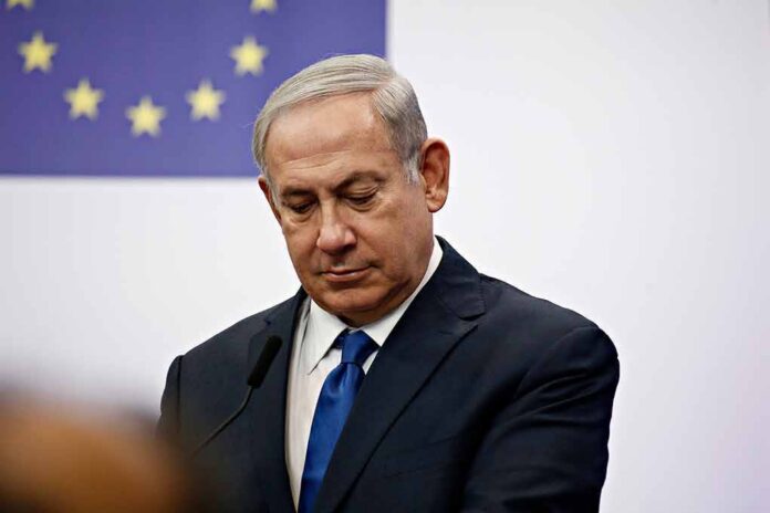 man in suit at podium with EU flag in background