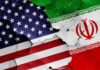 Gulf Mediators Tease ‘Encouraging’ Breakthrough United States and Iran flags on cracked wall