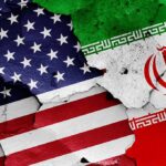 United States and Iran flags on cracked wall