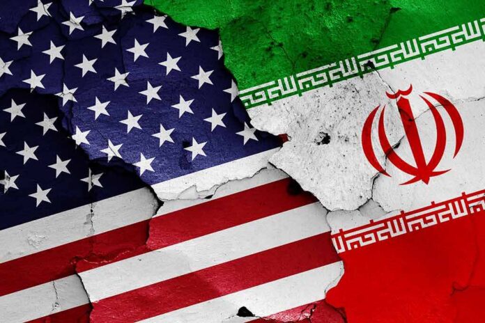 shutterstock_1152300314 United States and Iran flags on cracked wall