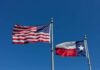 American and Texas flags waving on flagpoles