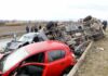 Overturned truck and damaged cars after highway crash