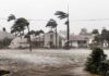 Houses battered by hurricane winds and flooding