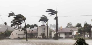 Houses battered by hurricane winds and flooding