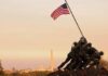 Iwo Jima Memorial with soldiers raising the American flag at sunset