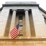 American flag hanging on a neoclassical government building