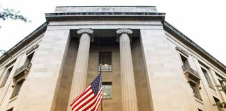 American flag hanging on a neoclassical government building